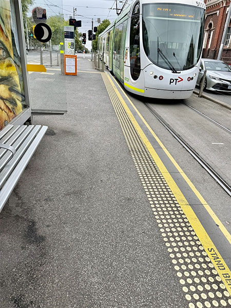Tram with level parking to platform, Braille Tactile Indicators on the platform and contrasting colours plus yellow edge where platform ends and tram line begins