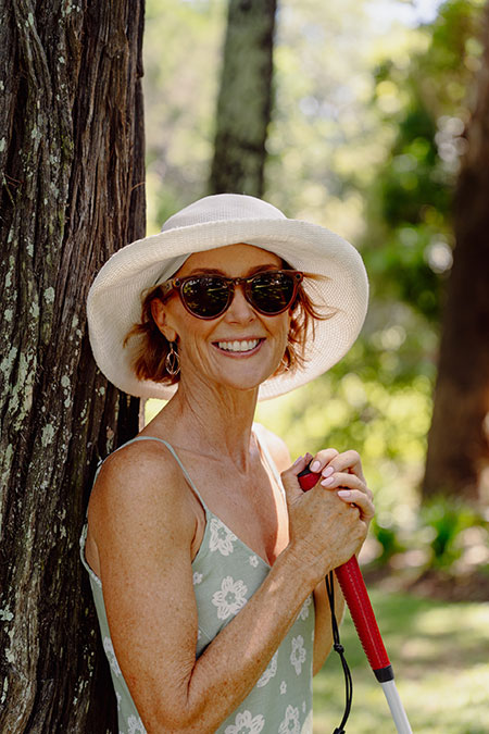 jo standing again a tree